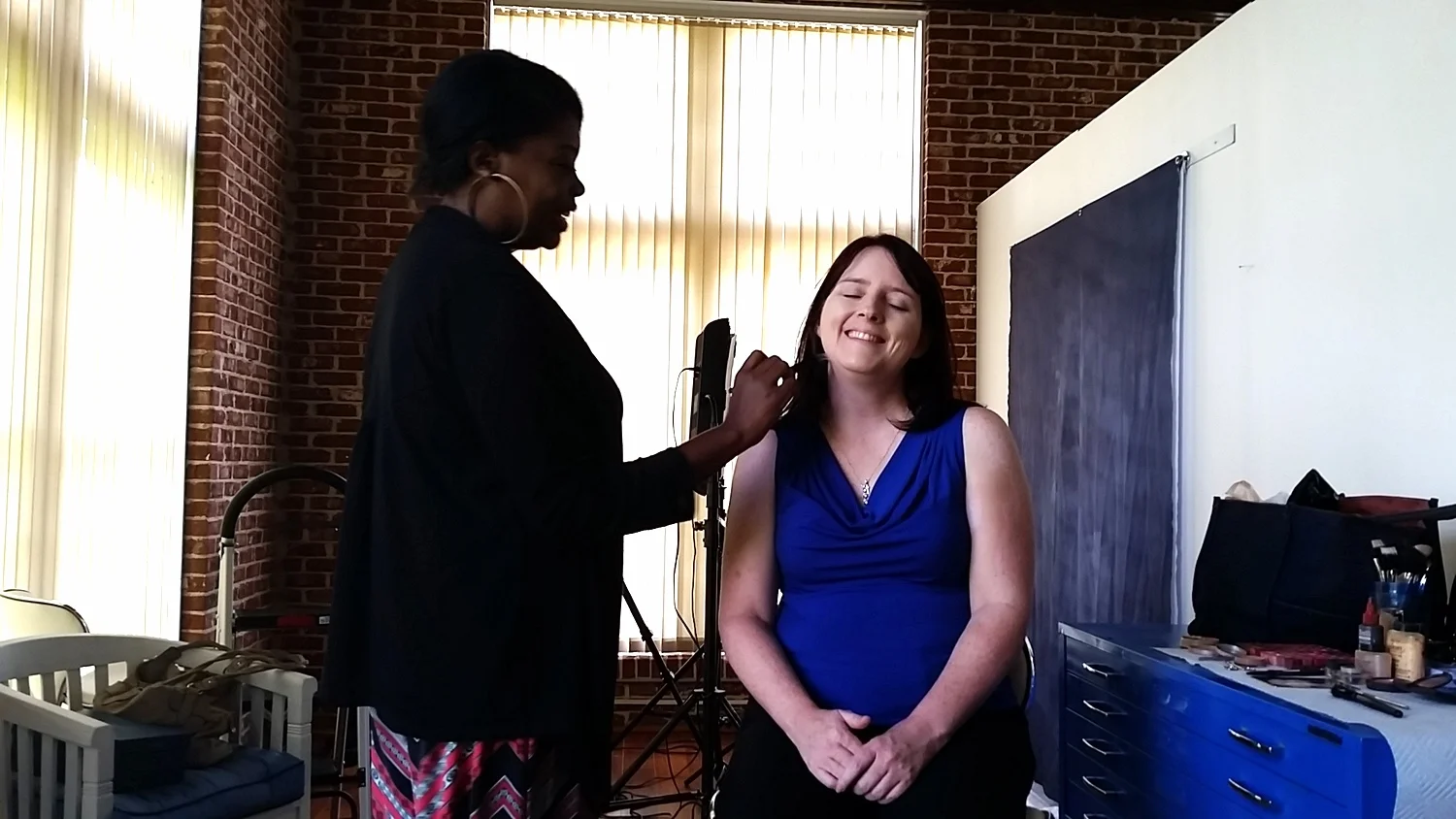Stephanie gets Sheryl ready for the shoot.