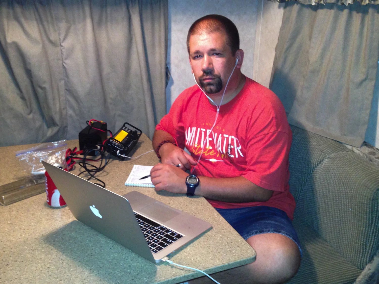 John (NG0R) operating the Elecraft KX3 from the inside of the camper on a buggy night.