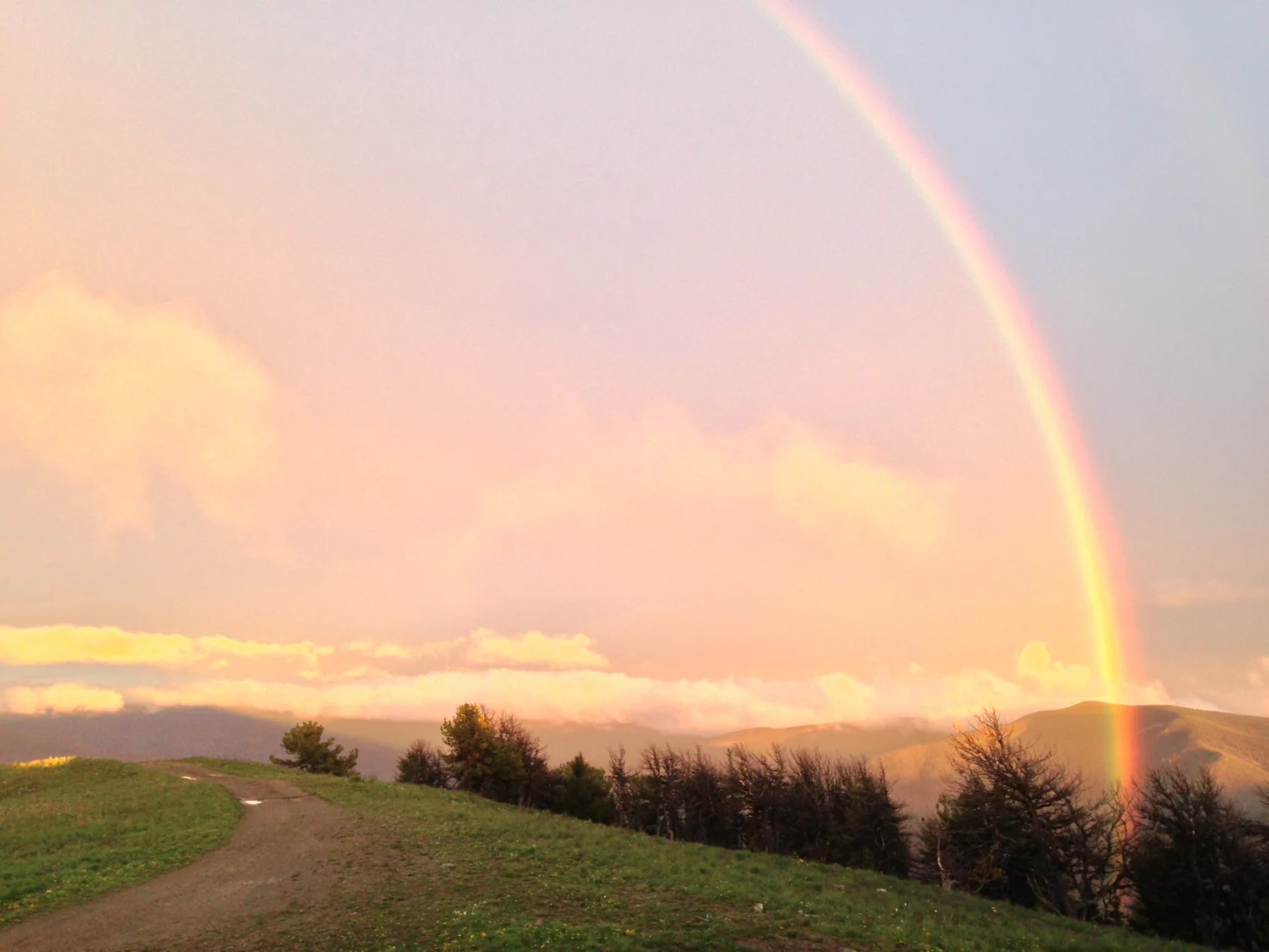 Rainbow between showers and sunset