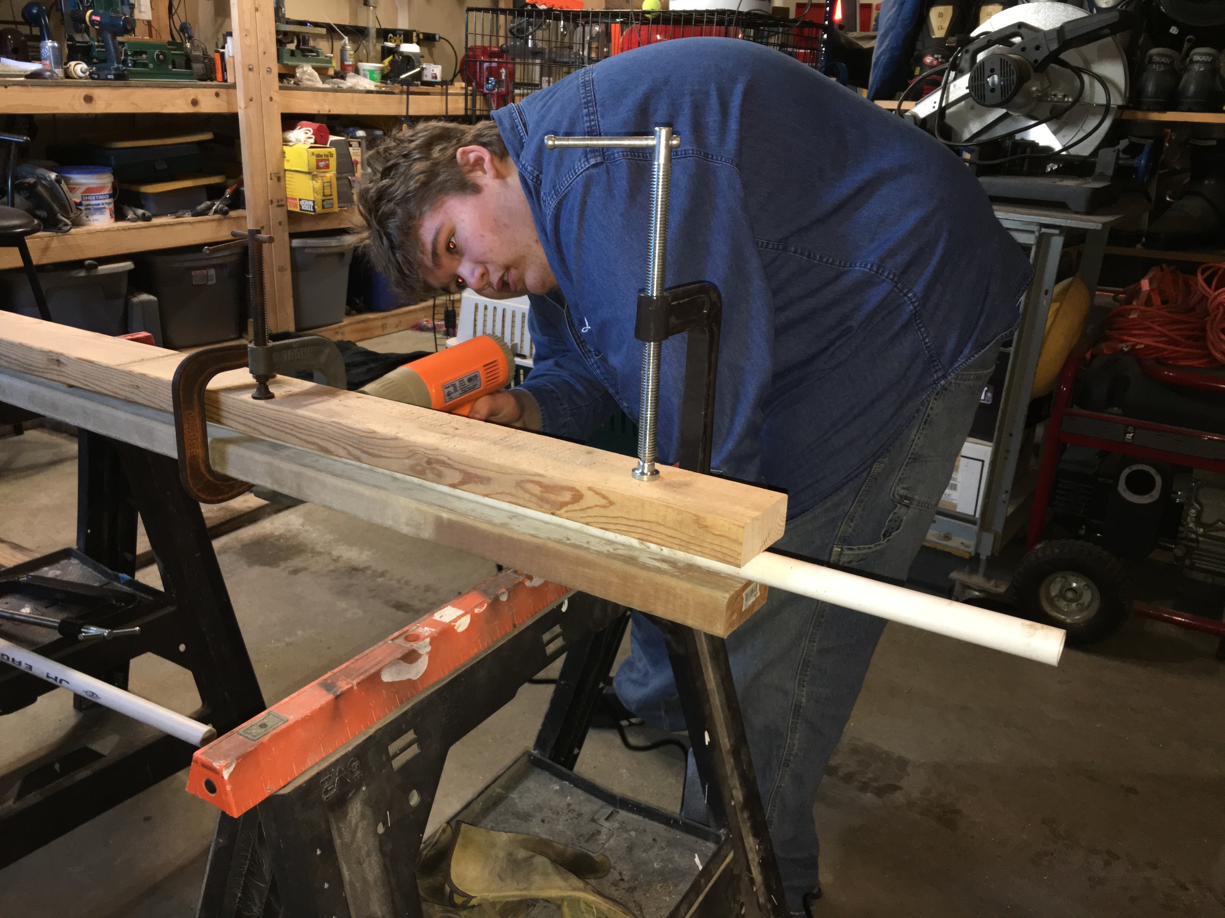 Jacob heating up some PVC for a DIY bow project