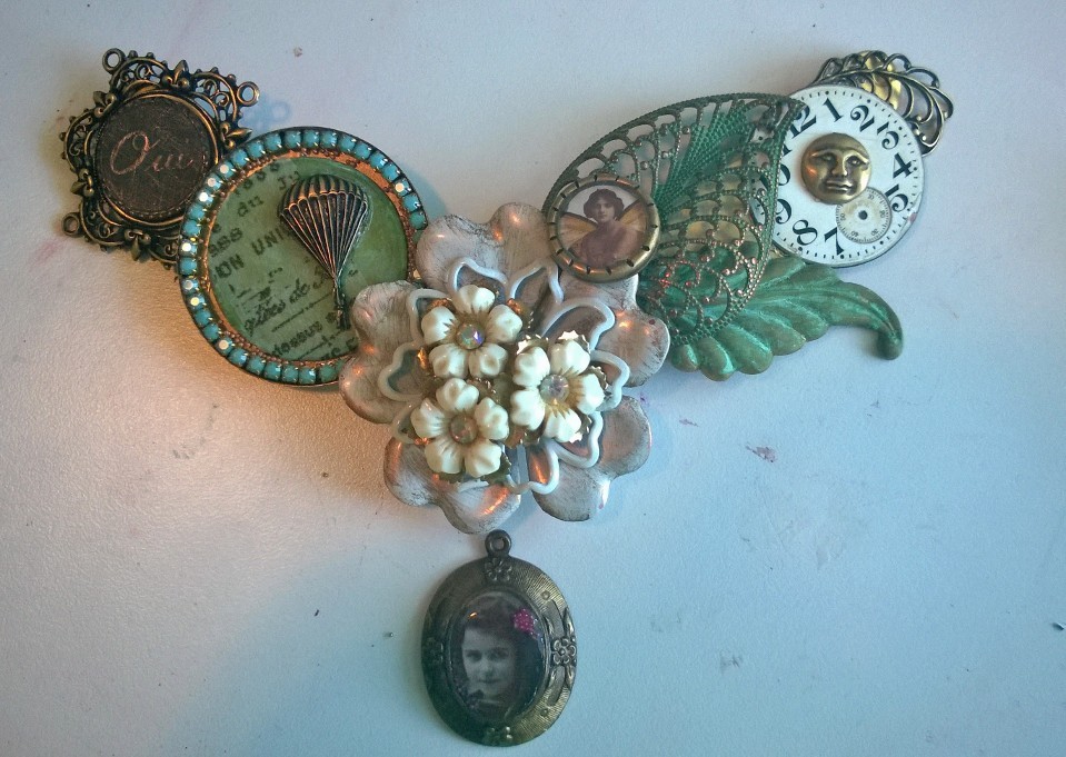 Vintage earring, mixed media bezel, Victorian imagery under resin, clock face, leaves and who knows what else!