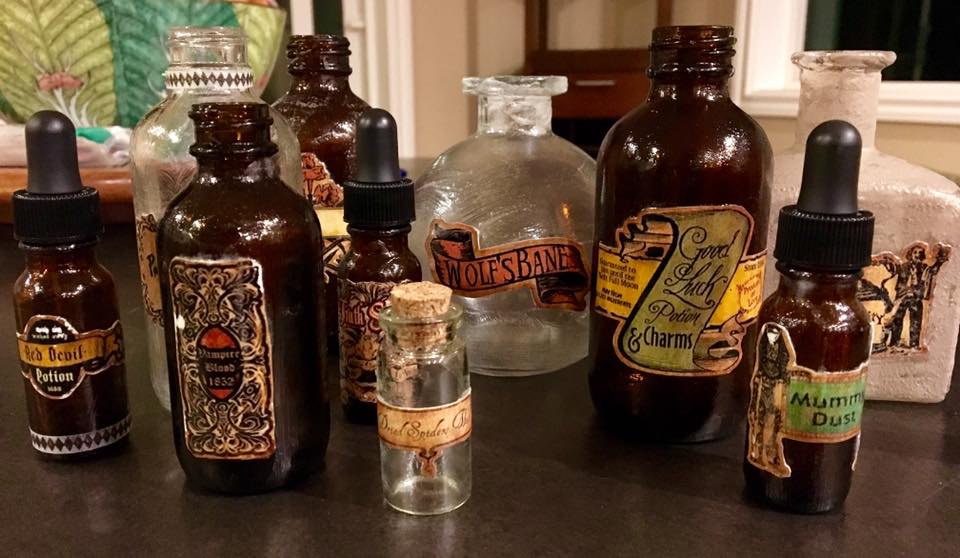 Potion bottles coming together! I didn't take pictures of how I did this, but I used decoupage glue to labels to the bottles and covered the entire bottles with the glue. On some bottles, I painted on top of the glue once it dried to give texture and aging to the surface.