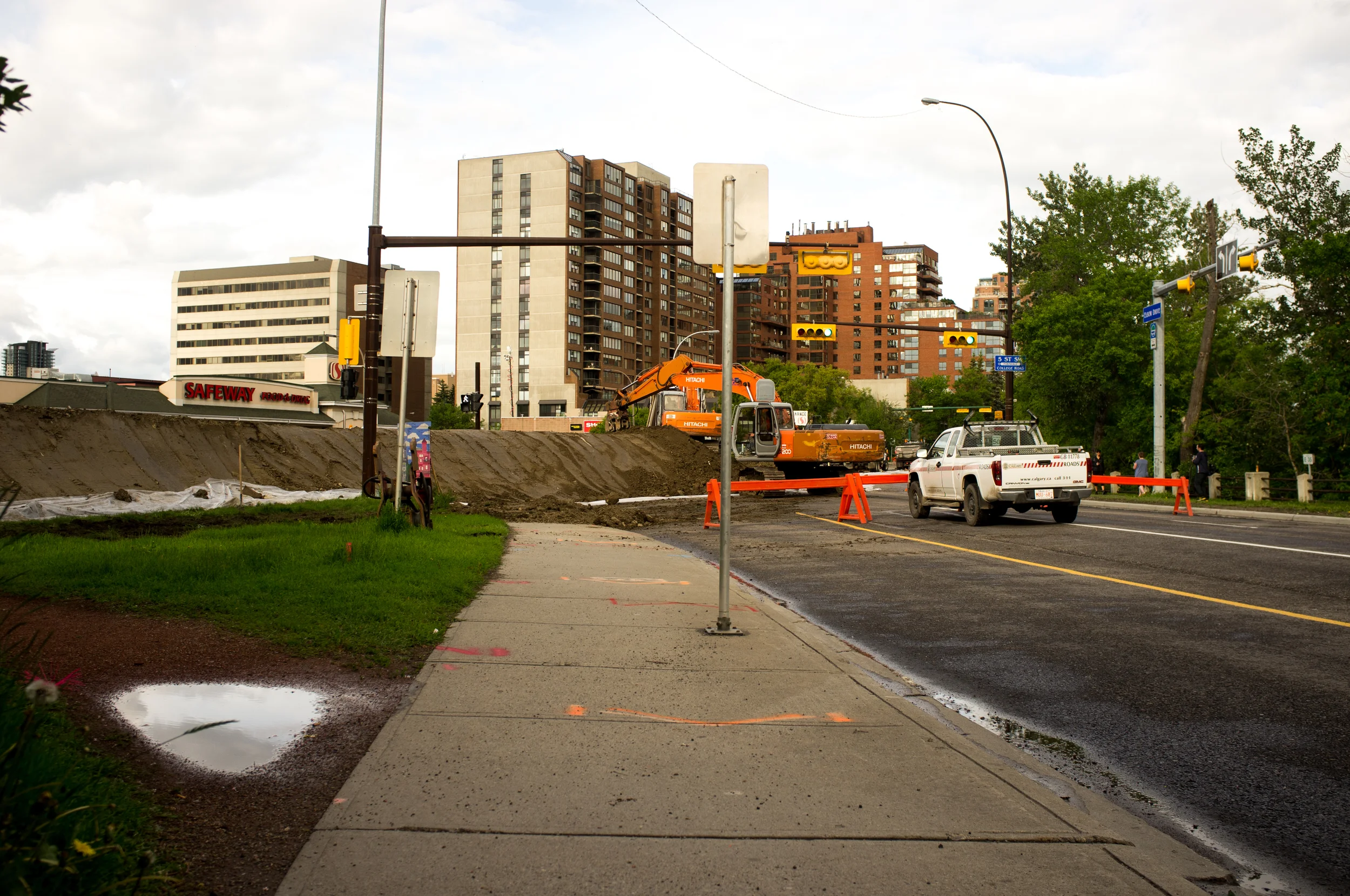 Mission. Workers rush to build an earthen berm in the same location as the flood of 2005. A City of Calgary Roads worker told me they had 25 dumptrucks on the job, working in constant rotation at this location—similar setups were in operation around the downtown core.