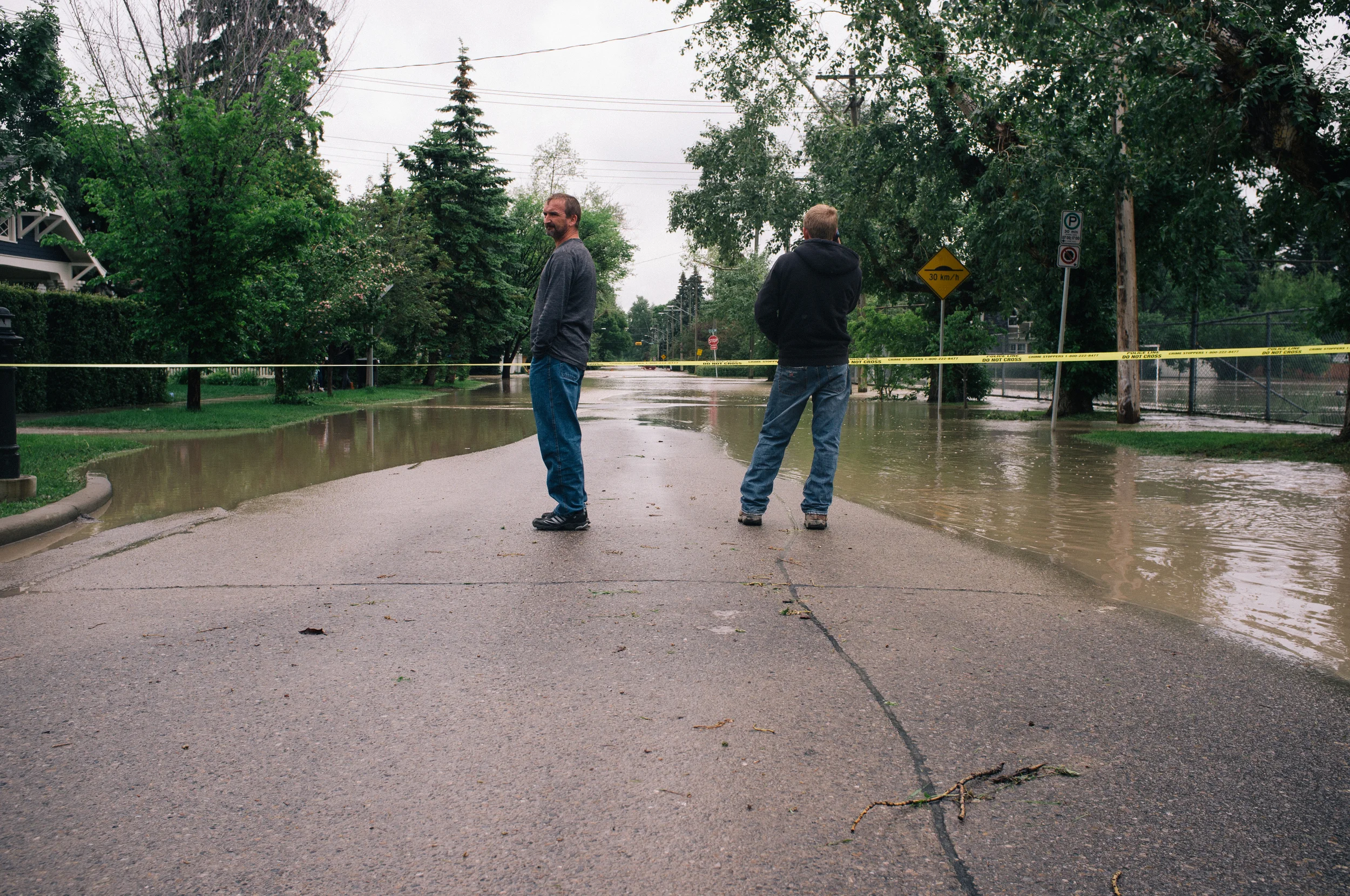 Locals surveying their homes. 38th Avenue SW and 7A Street.