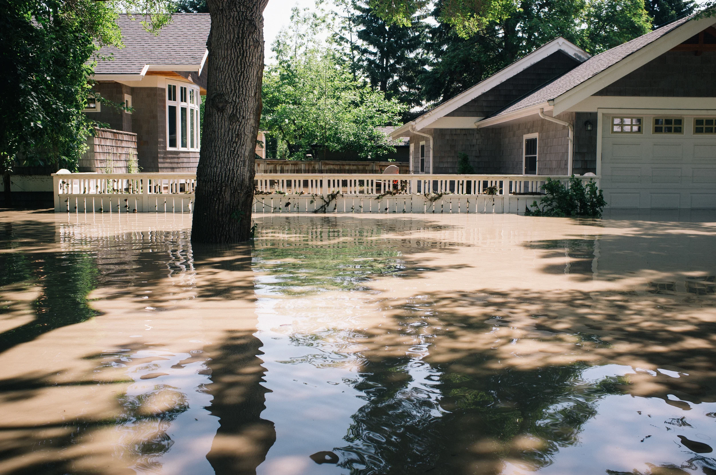 The current was pulling hard to the east, downstream. Waters visibly lowered while I was in the vicinity. A line on the garage door shows peak height was to the top of the fence. East Elbow.