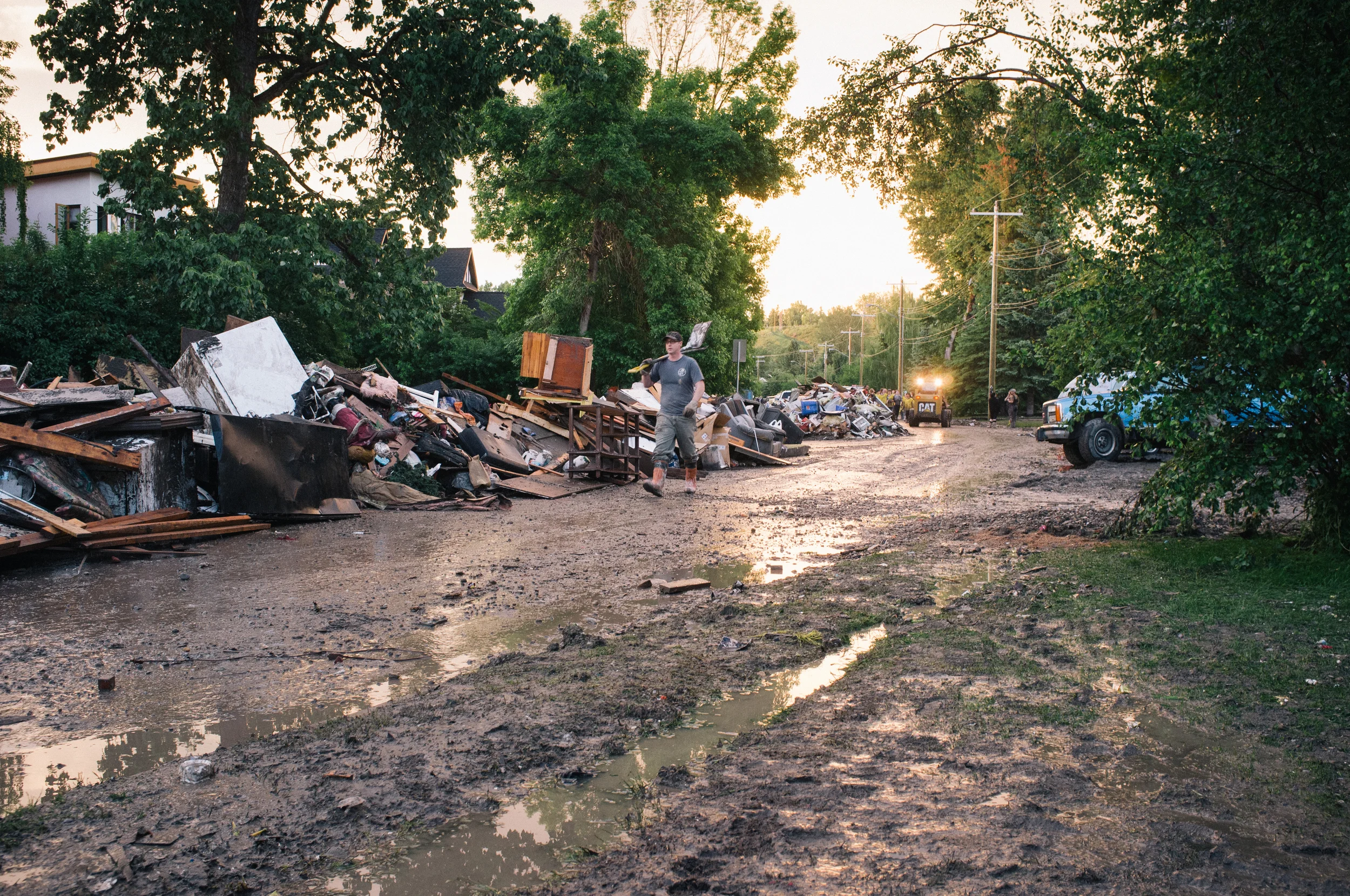 Residents and volunteers begin the process of cleaning up the remains of homes on Bow Crescent. At one home I visited, the highwater mark had breached 4'. Bowness.