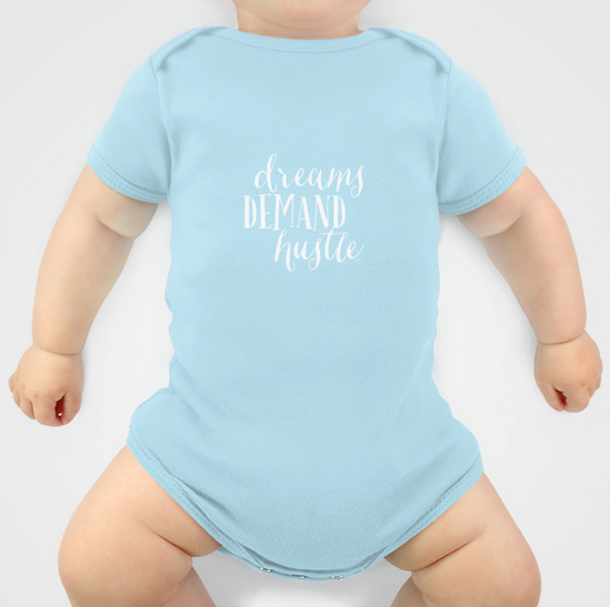 Dreams Demand Hustle Onesies . Available in a variety of colors and sizes. 