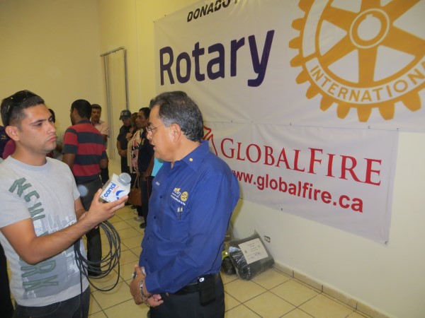 Pres Silva with GF Rotary background and medai.jpg