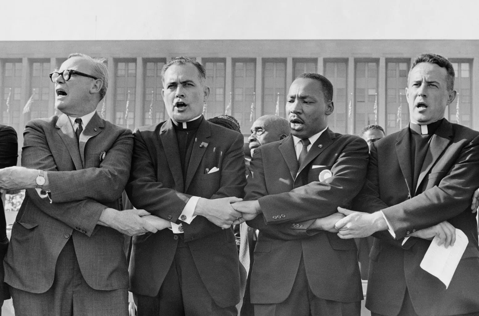 Father Hesburgh together with Rev. Martin Luther King Jr., singing "We Shall Overcome."