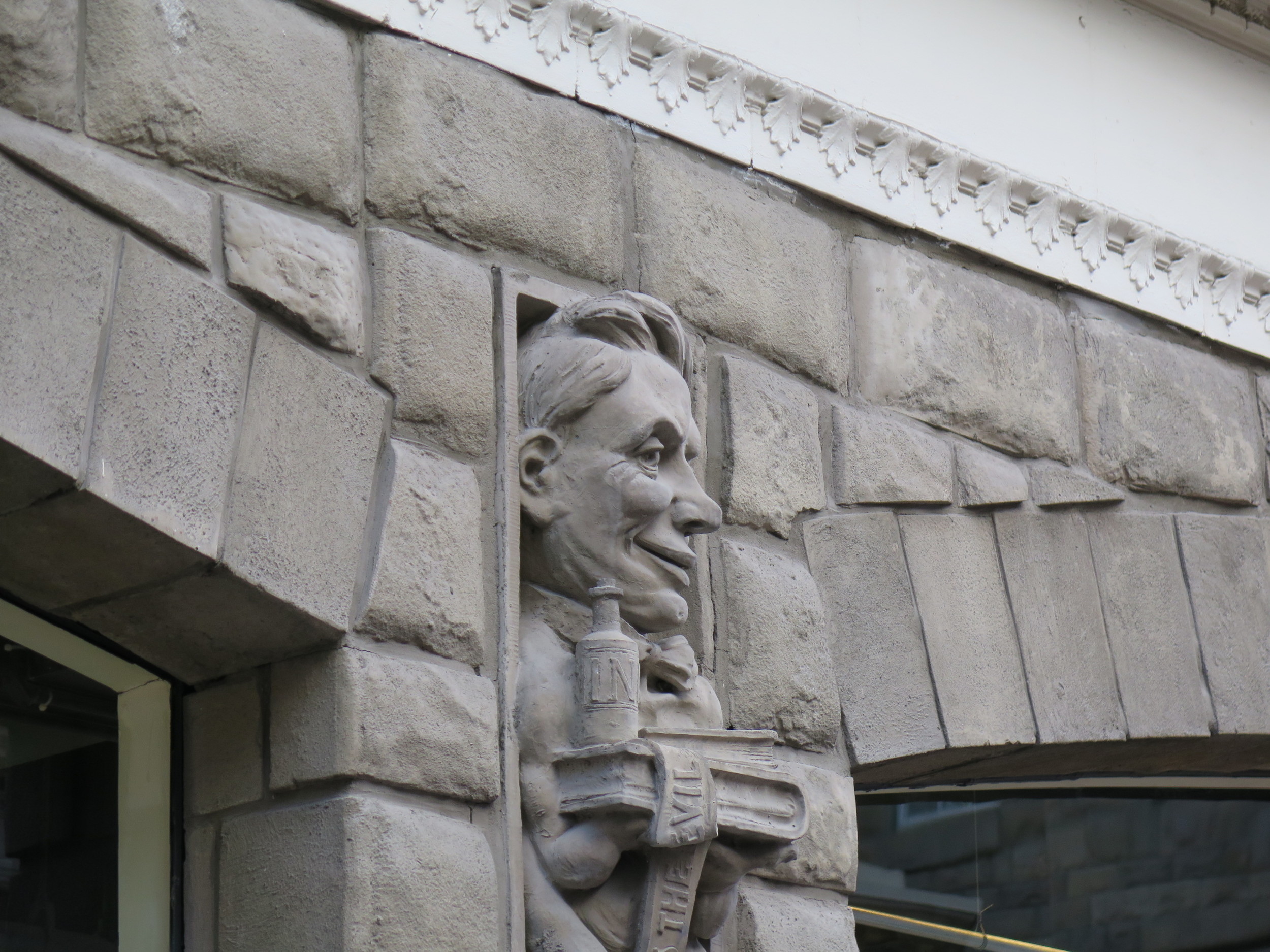 One of the Calgary Herald gargoyles on the historic Alberta Hotel building: a medieval feature with a contemporary twist. Figures depict newspaper staff members, including the stenographer and the cleaning lady.