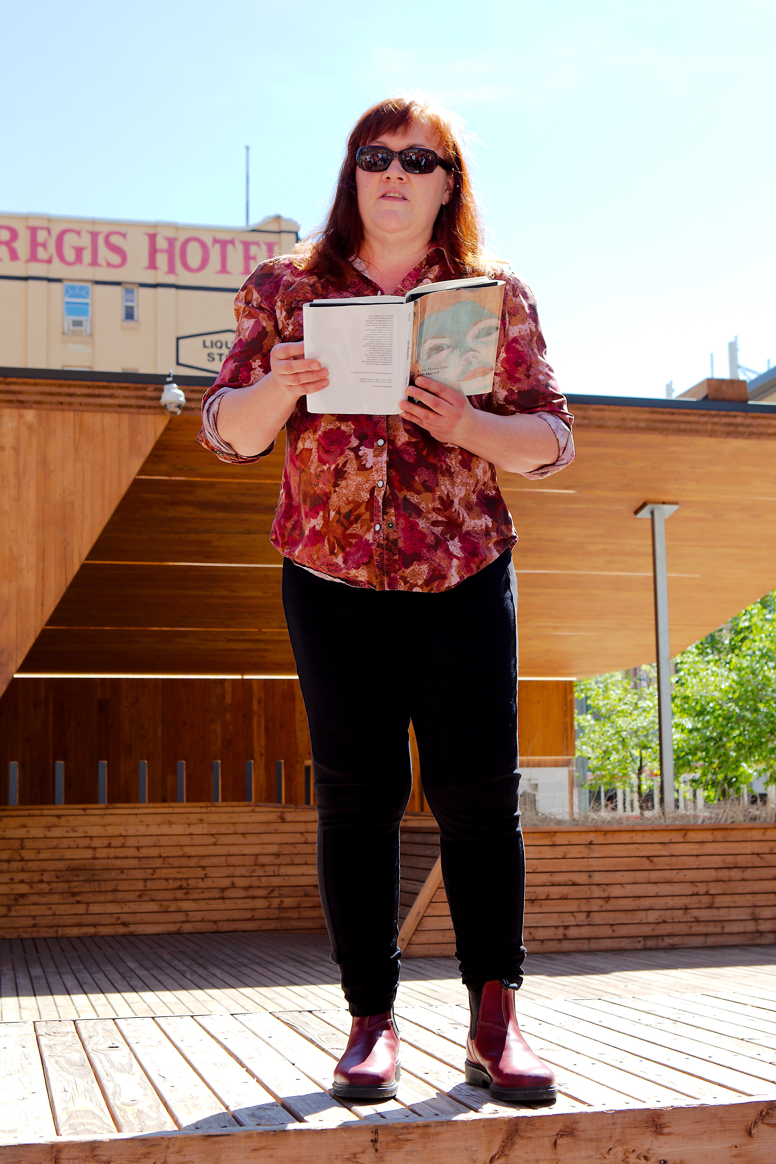 Near the site of the Calgarian Hotel on 7th Ave East: author Lori Hahnel reads a passage from her 2008 novel, Love Minus Zero. The scene takes us into the Calgarian Hotel, the epicentre of the city's punk rock era between 1979-82. (Photo: Reg Tiangha)
