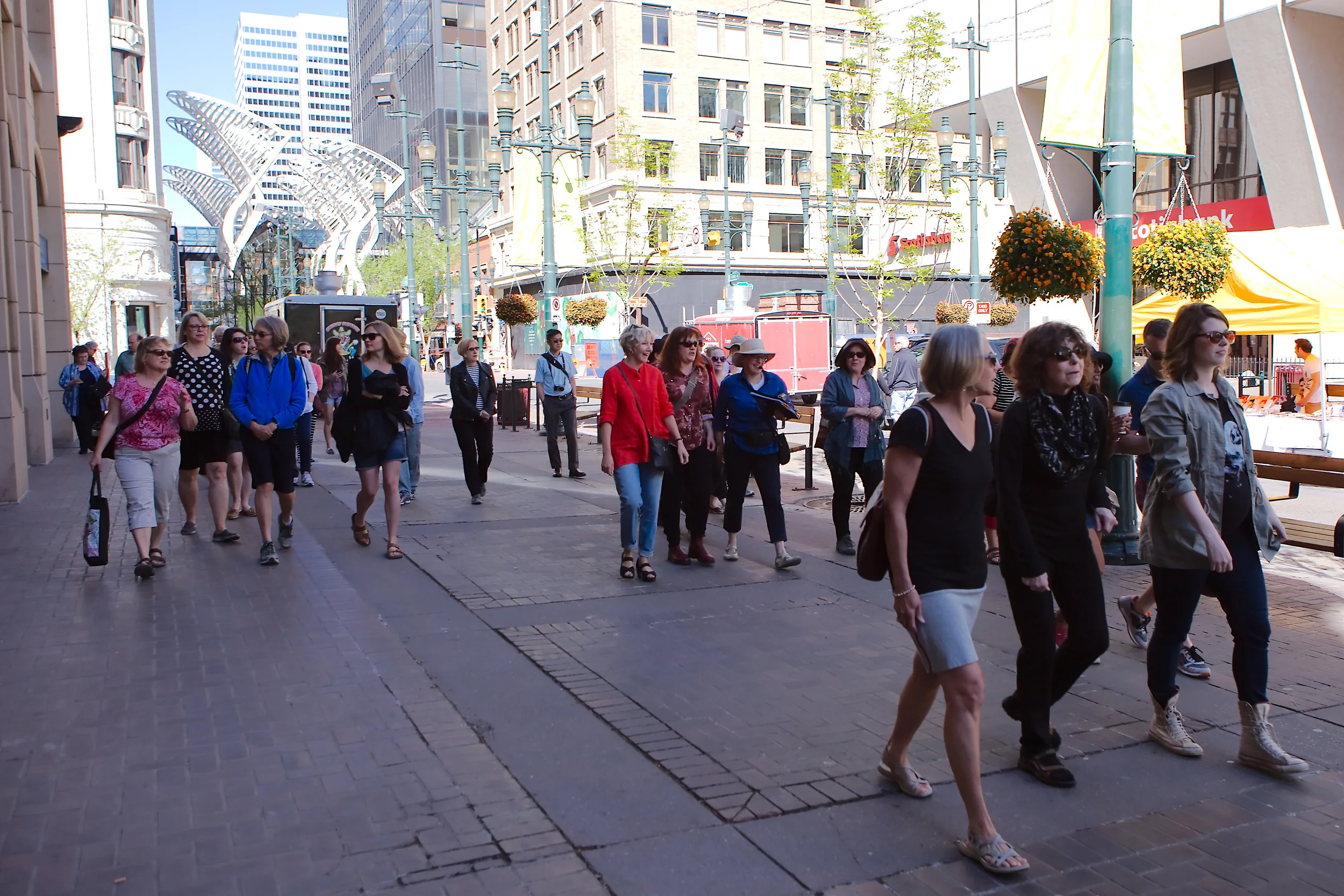 Stephen Avenue: A Jane's Walk parade down what was the 1912 Stampede parade route. Novelist Nancy Huston ( Plainsong ) and poet Yvonne Trainer ( Tom Three Persons ) capture two different aspects of Guy Weadick's first Stampede. (Photo: Reg Tiangha)