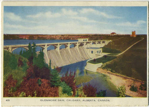 Completed in 1933 and costing $4 million, the Glenmore Dam was the largest public works project in the city's history, providing needed employment during the first years of the Dirty Thirties. The dammed Elbow River flooded 900 acres of land to create the Glenmore Reservoir. In the 1940s, the area was considered a "swimming, fishing and picnicking paradise." Later, the reservoir was closed to swimmers and power boaters, but not to the literary imagination. (Photo: Calgary Public Library Postcards from the Past )