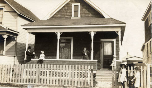 Calgary's Boyer family on the porch of their home at 819 - 5th Ave NW. As the crow flies, this house is not far from the peninsula in what Catherine Simmons calls one of her Calgary porch stories. The Boyers' house was scheduled for demolition in 2013. (Photo: Calgary Public Library Postcards from the Past )