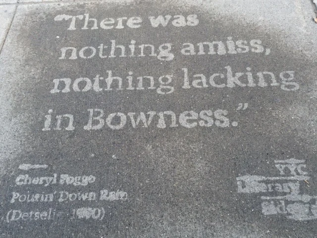 In front of Cadence Coffee in Bowness: the first line of Cheryl Foggo's 1990 Calgary memoir, Pourin' Down Rain.