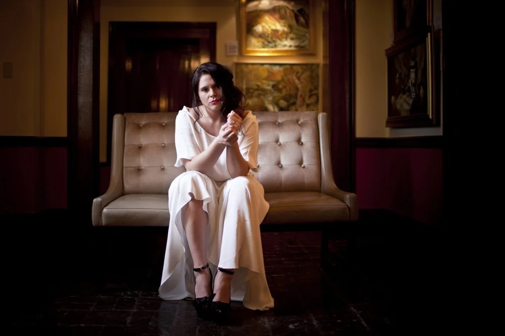 Holly posing in vintage-inspired silk wedding dress from designer Winifred Bean