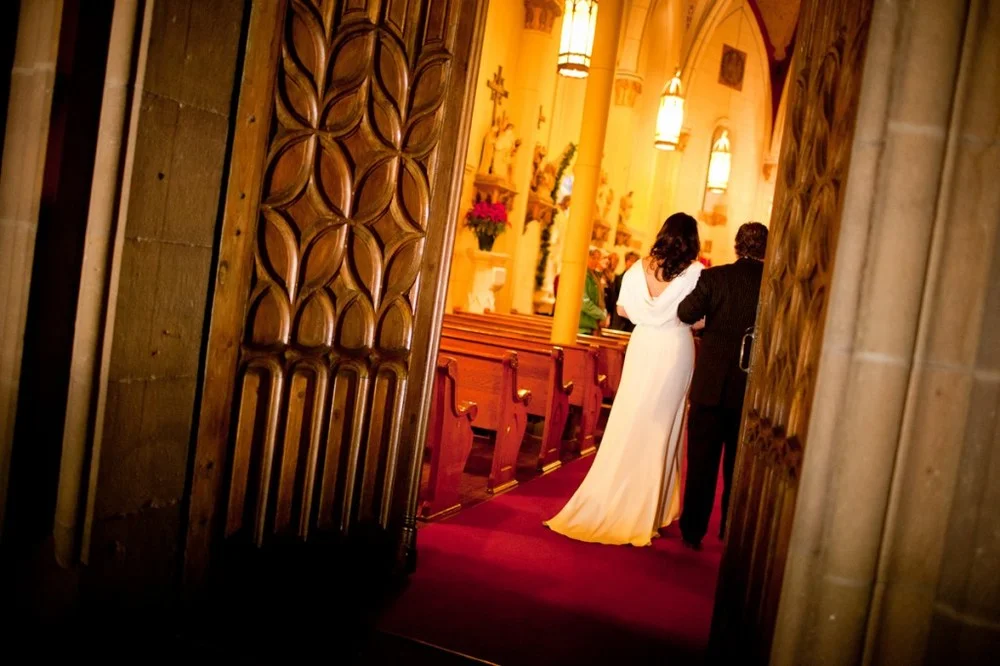 walking down the aisle in vintage-inspired wedding dress by winifred bean