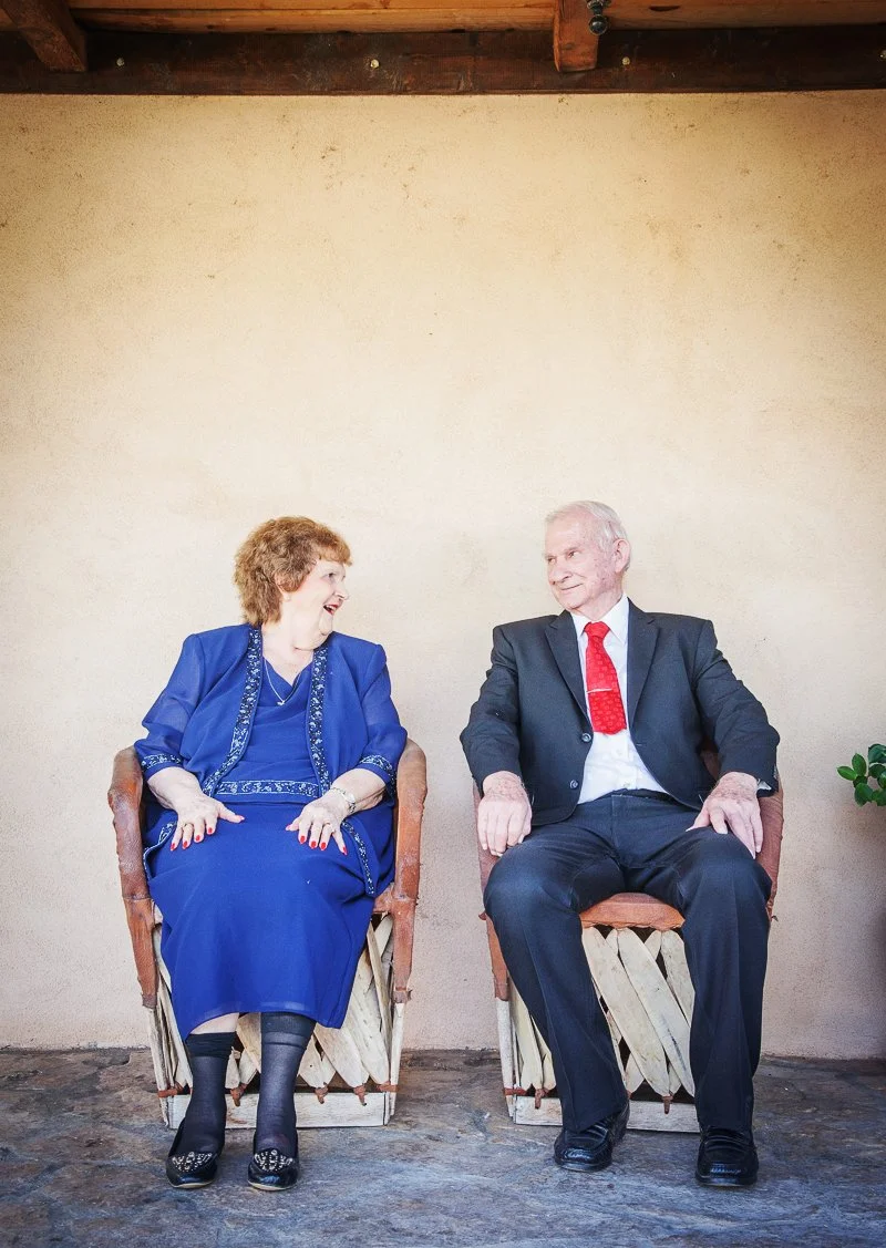 Elderly couple smiling at one another 