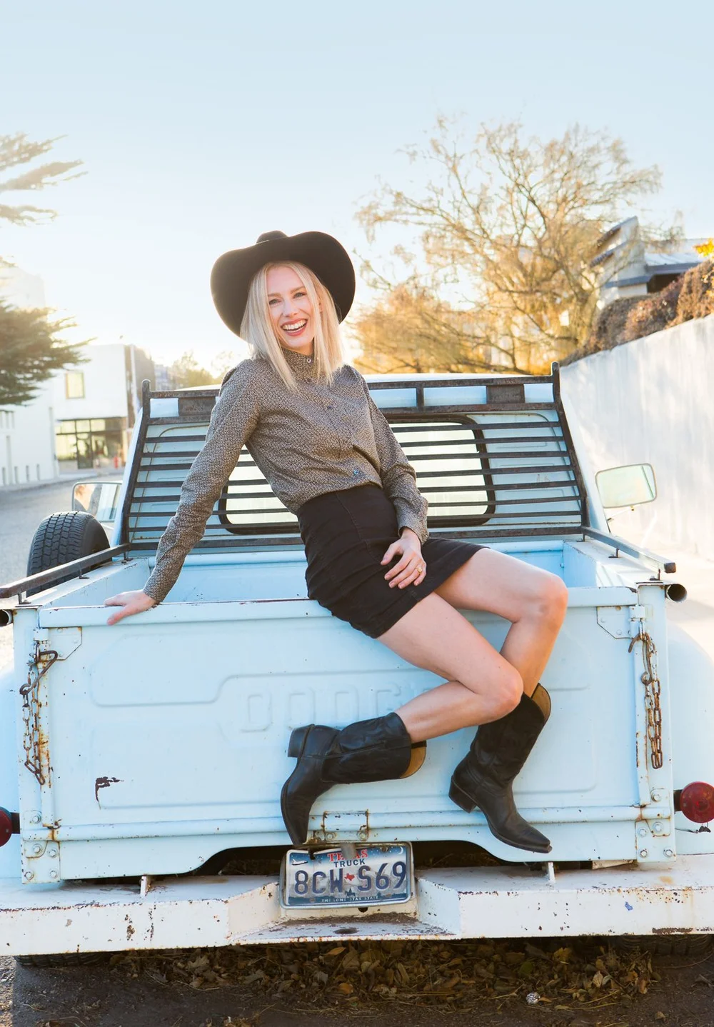 Woman on the back of a blue truck in Marfa, Texas 