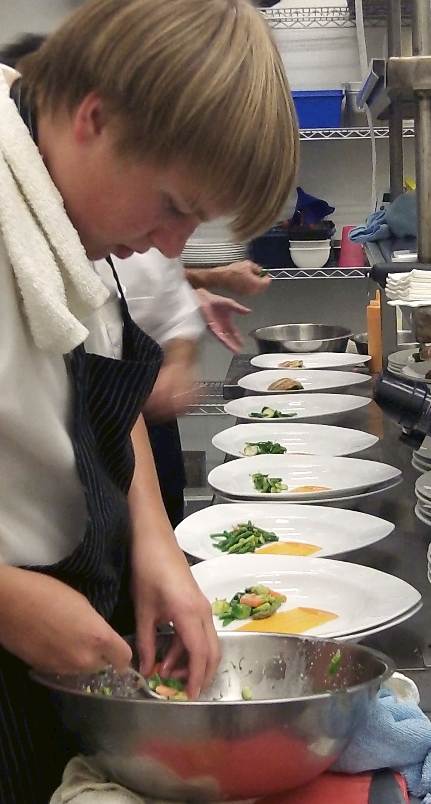 Chefs prepare redfish dish