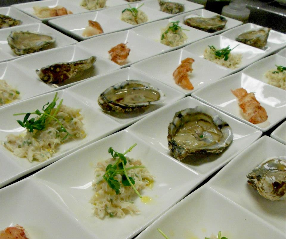 Maine shellfish trio, with oysters, lobster, and Jonah crab.