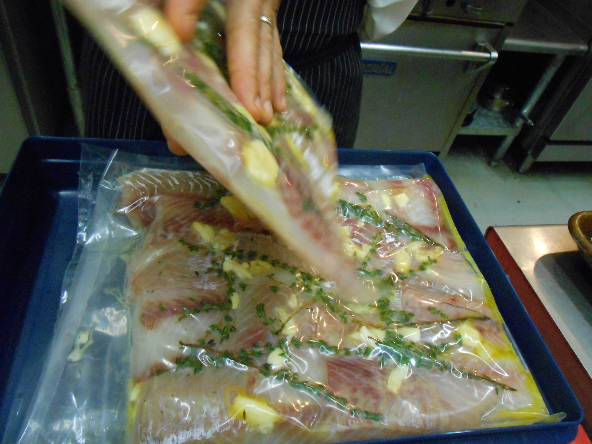 Pollock was prepared sous vide -- cooked in a warm water bath in a vac-pack bag with herbs