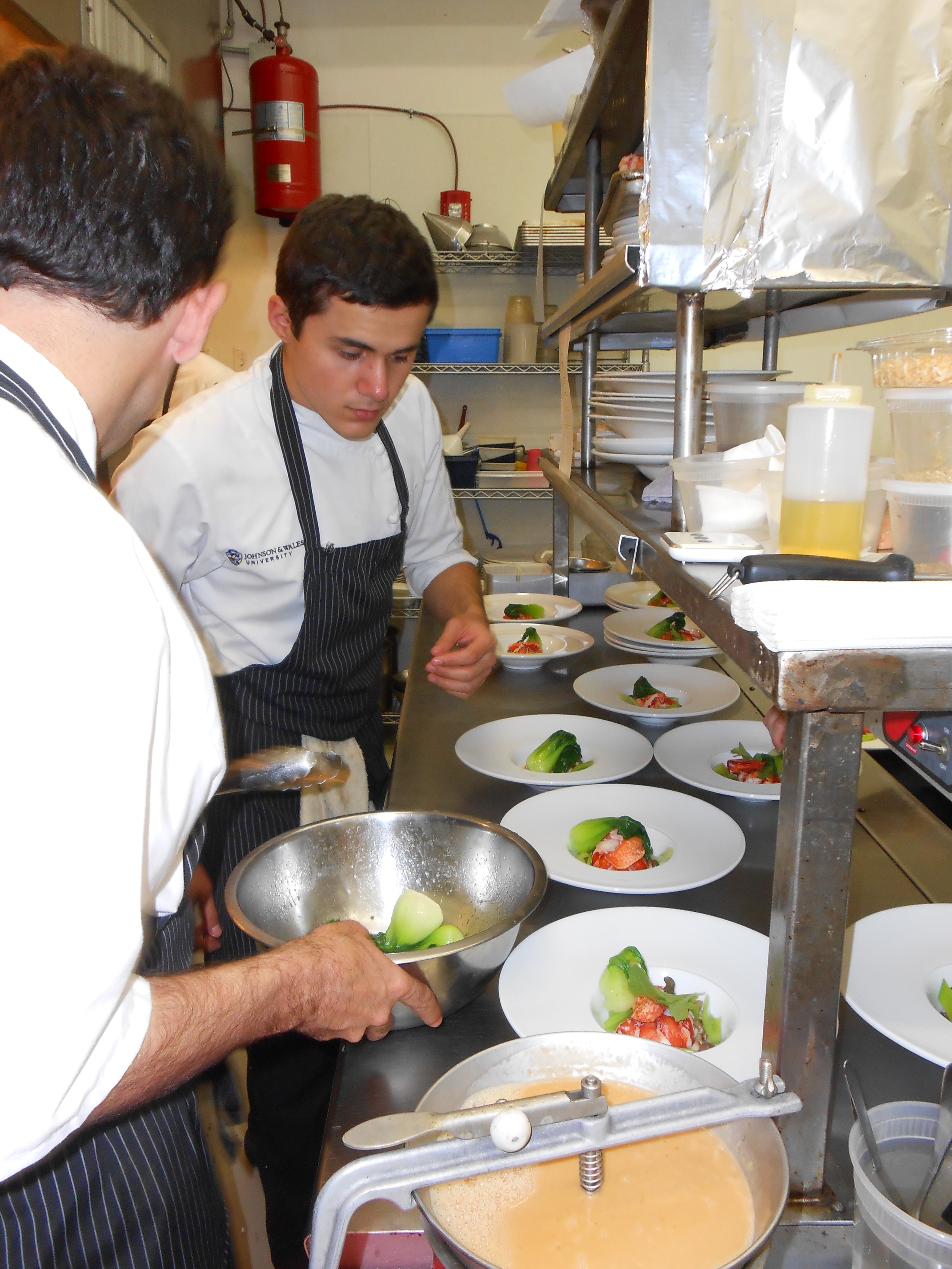 Chefs assemble the fourth course -- lobster