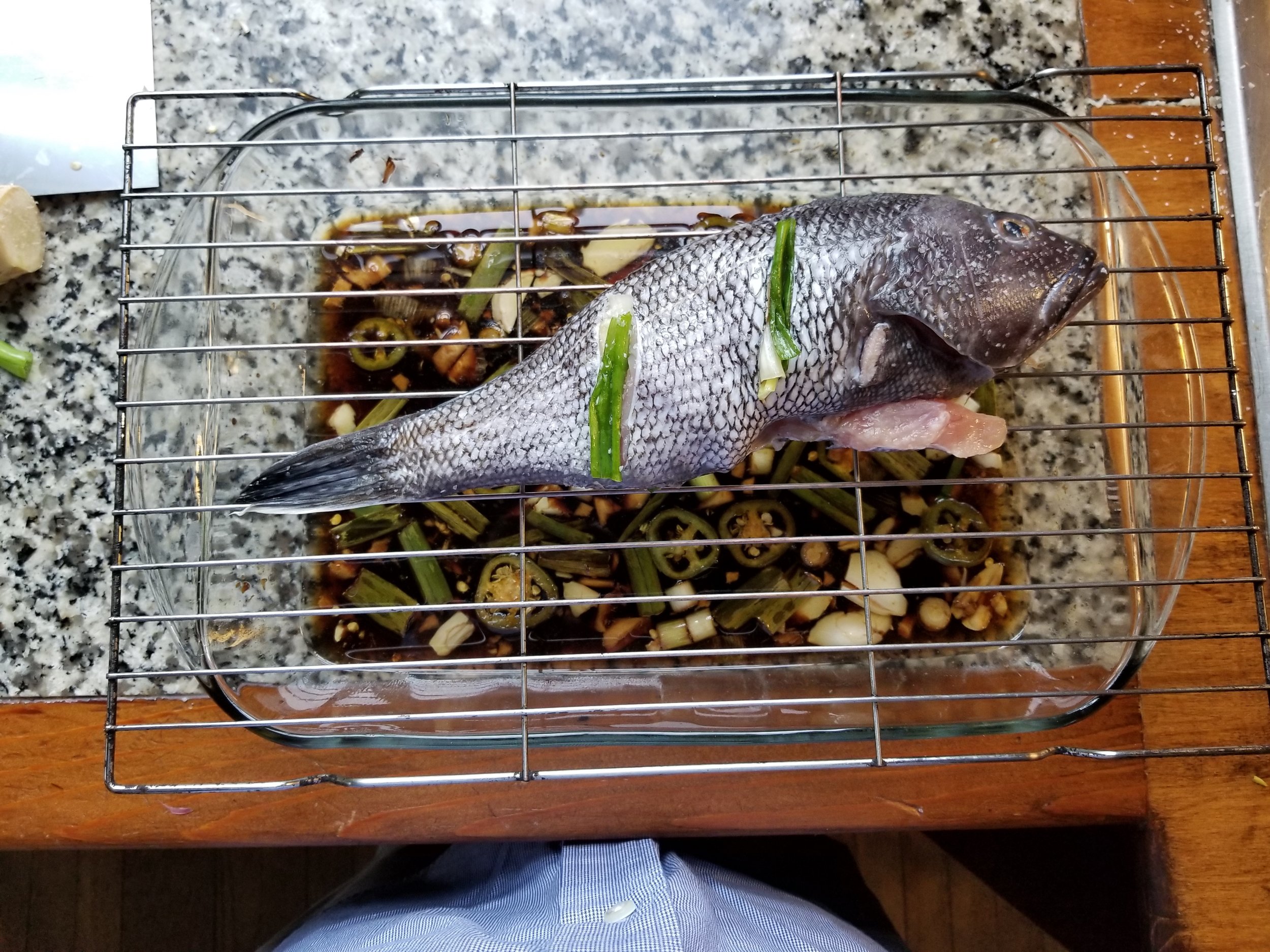 whole black sea bass steamed over soy ginger scallion