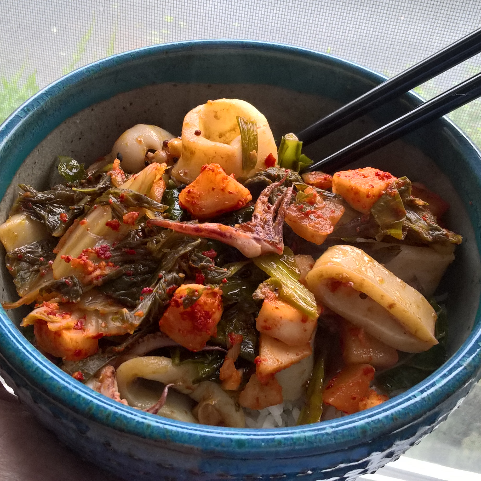 Spicy squid with greens & kimchi over rice.