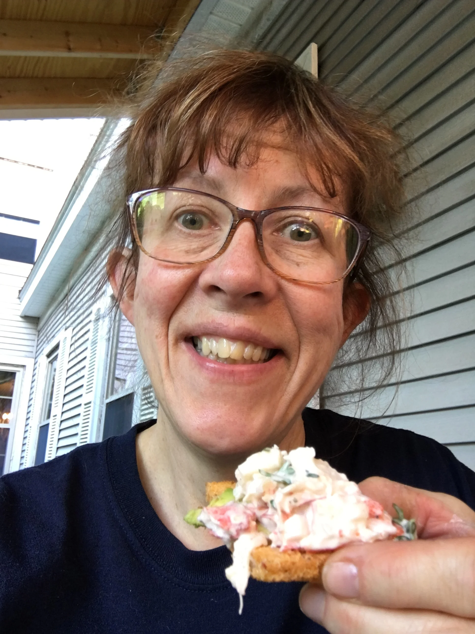Happy girl eating lobster salad