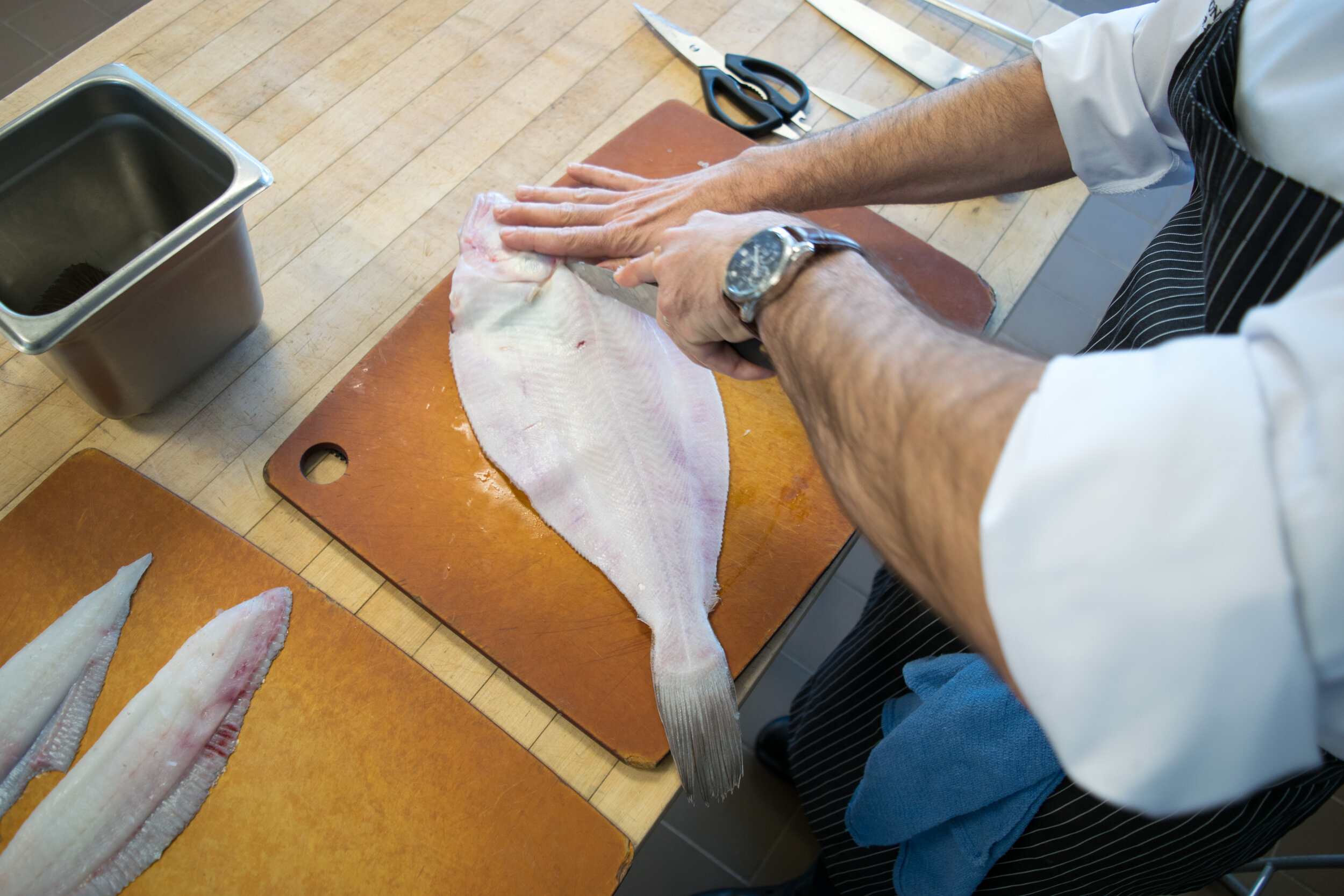 Step 7. Flip the fish over and follow the lateral line on the bottom of the fish with your knife.