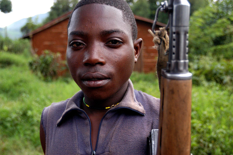  Ombeni Balihiamwabo, 17, stands with his rifle Thursday Dec. 9, 2004, outside a military post in Nyangonbe, in the Democratic Republic of Congo. The integration of the former militias in the new Congolese army is a priority task for the transitional