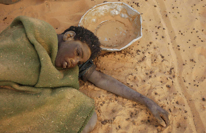  A wounded young girl waits for medical care near Tine, 3 February, 2004. Photo: Photo: Olivier Jobard/SIPA. 