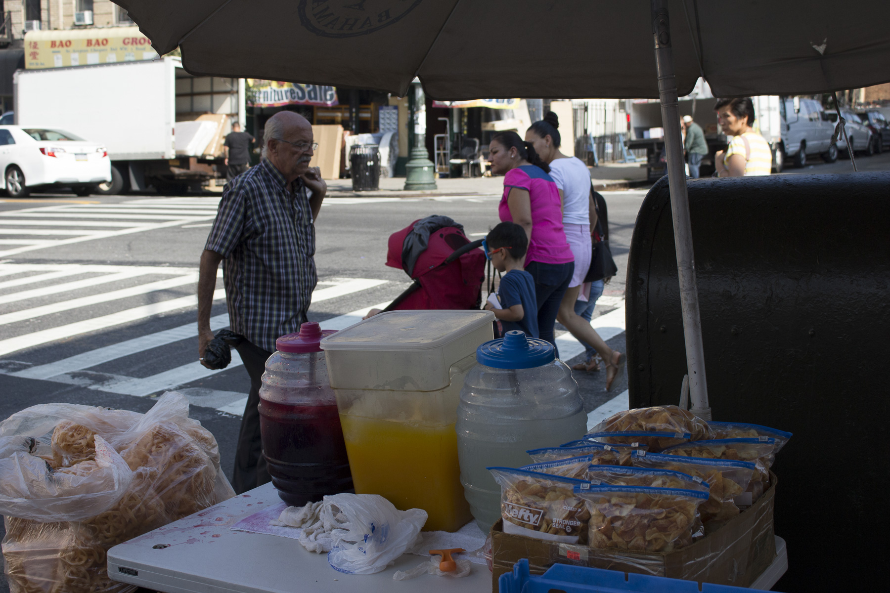  A view of the busy 5th and 56th street corner on a hot 22nd of August, 2017. Pictured is her homemade potato chips, limonada, jugo de mango, and jamaica. 