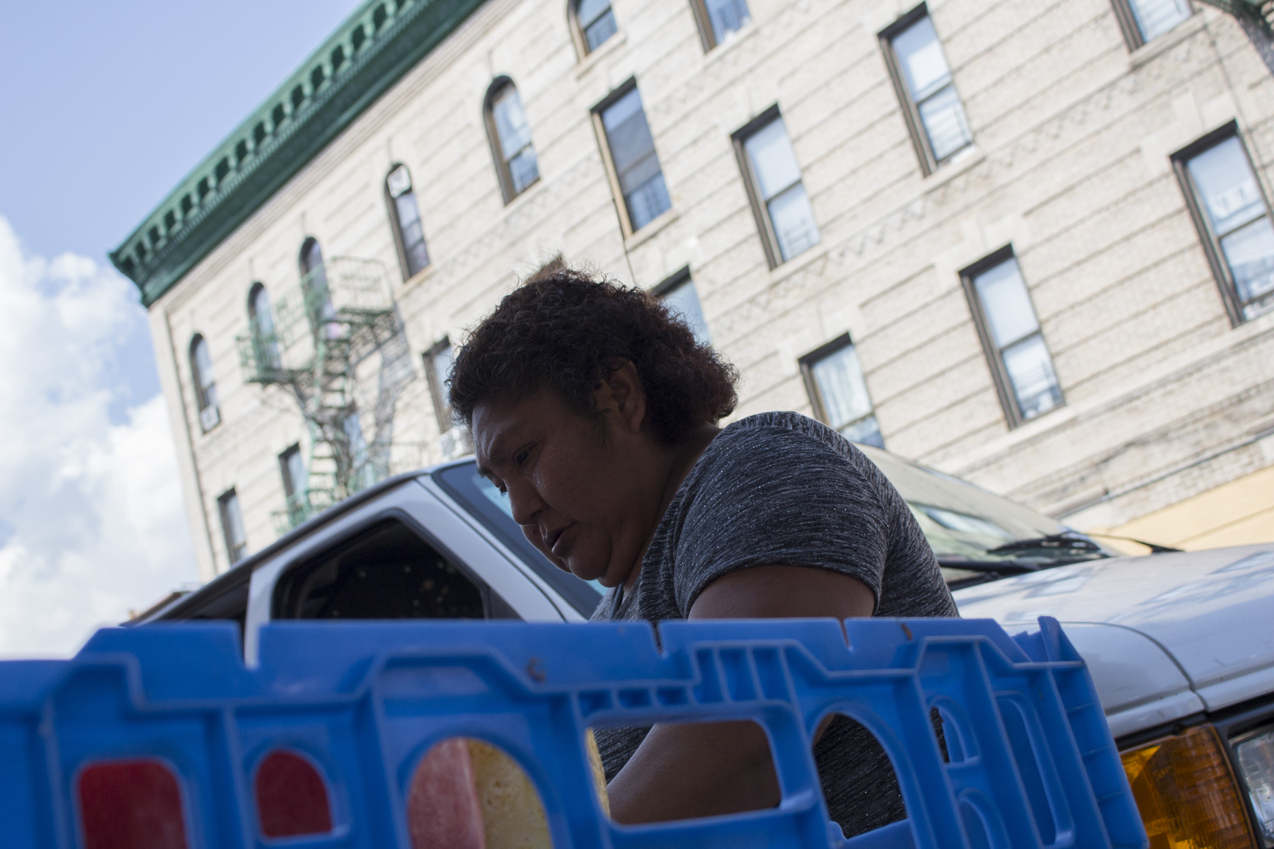 Teodosia cuts fresh fruit each day to pack into containers to sell. On August 22nd, 2017 she is cutting mangoes, honeydew, cantaloupe, pineapple, and watermelon in Sunset Park Brooklyn.