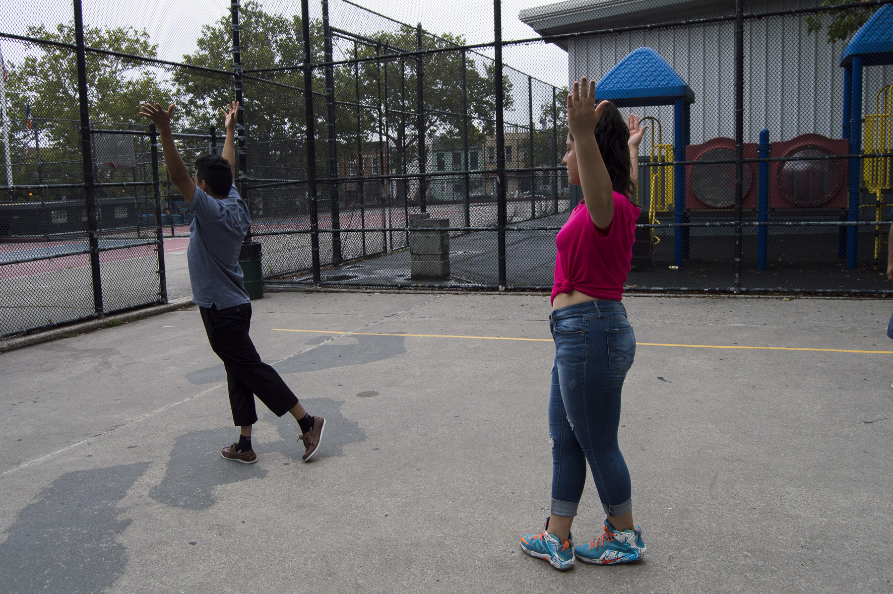  Benito Bravo shows the quinceñera how to hold her arms. Gabrielle Narcisse and Deleelah Saleh for Picture Justice.&nbsp;August 17th, 2017, Brooklyn, Hena Perrera Park, 47th and 4th ave. 