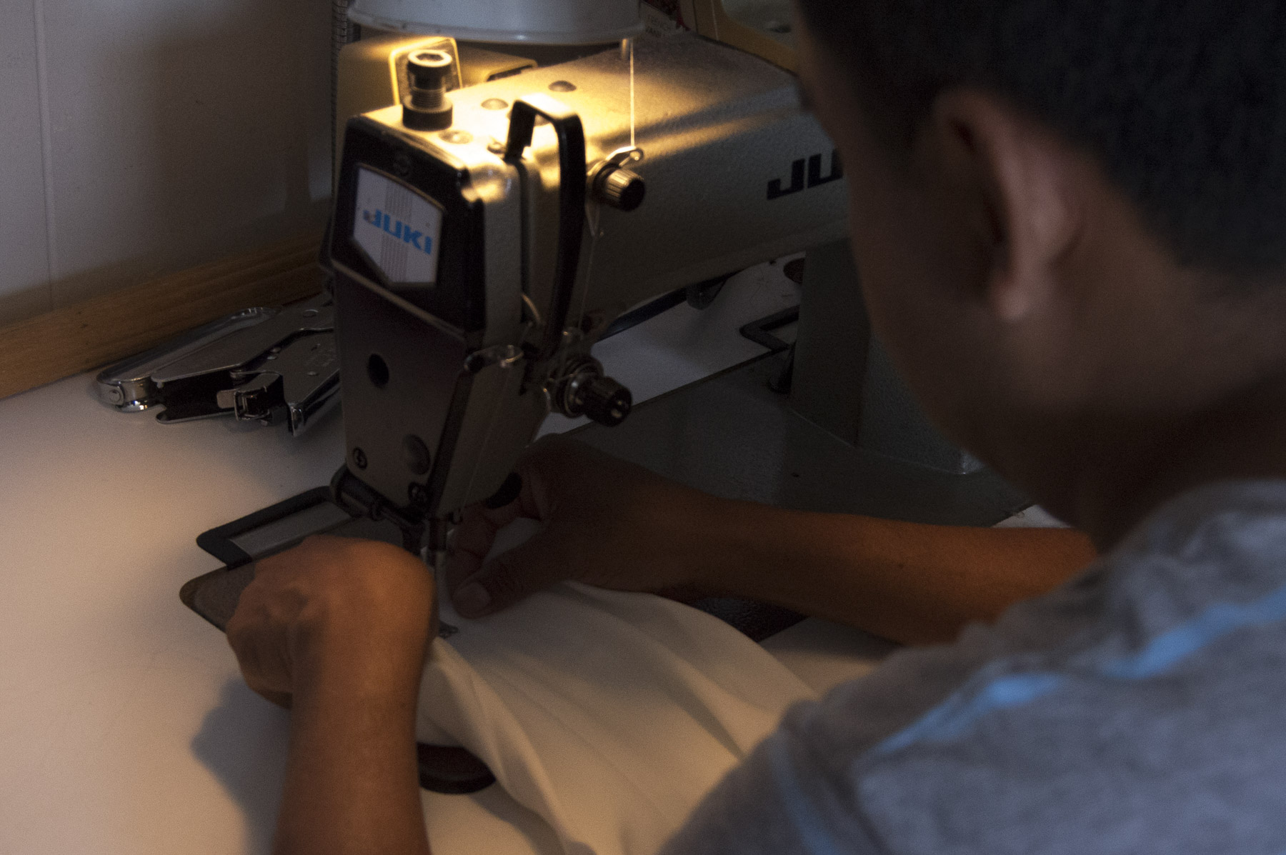  Benito Bravo sits at his sewing machine and alters José’s costume. Gabrielle Narcisse and Deleelah Saleh for Picture Justice.&nbsp;August 22, 2017, Sunset Park.&nbsp;    