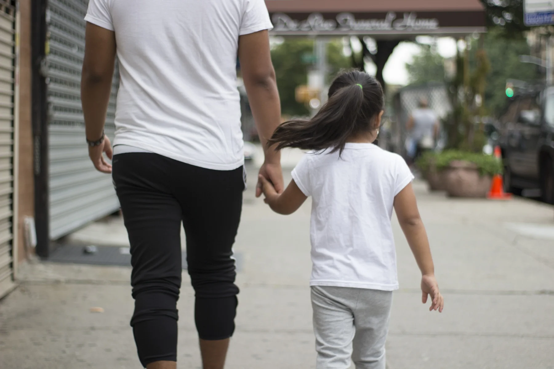 Carlos walks his younger sister to school. August 22, 2017