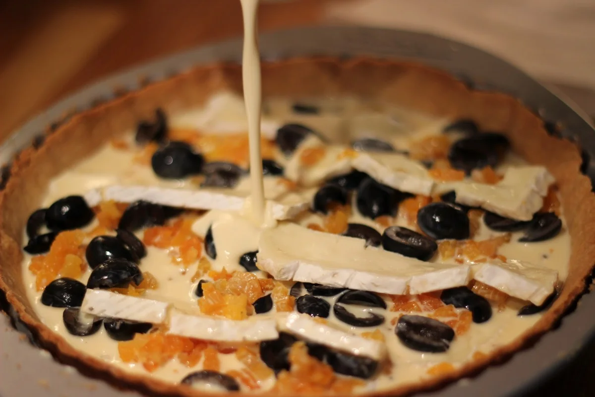 Camembert, black olive and apricot tart