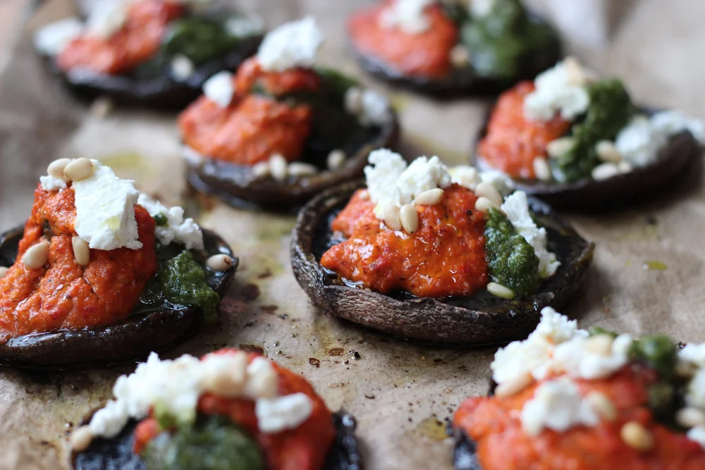 Portabella mushrooms with romesco sauce, fresh pesto and goat’s cheese