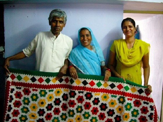 Master quilt-makers, Rhymill and wife and daughter, with one of their quilt designs