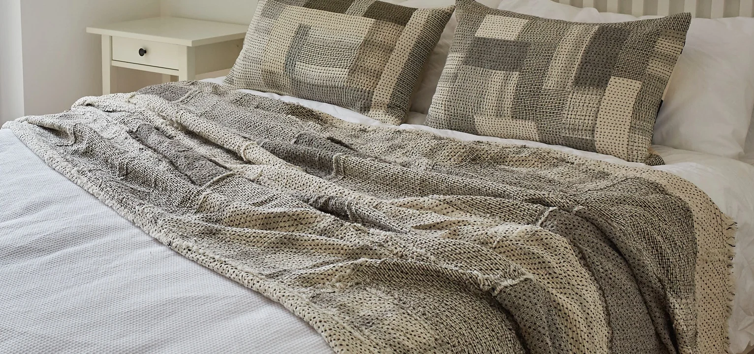 The Raw Chindi Quilt, inspired by Japanese Boro fabrics, is made from a patchwork of kala cotton fabrics, sewn with the raw edges on the surface
