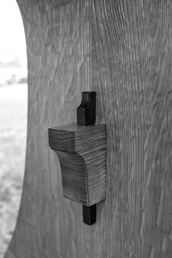 The table stretcher connects the trestles with a wedged through-tenon.