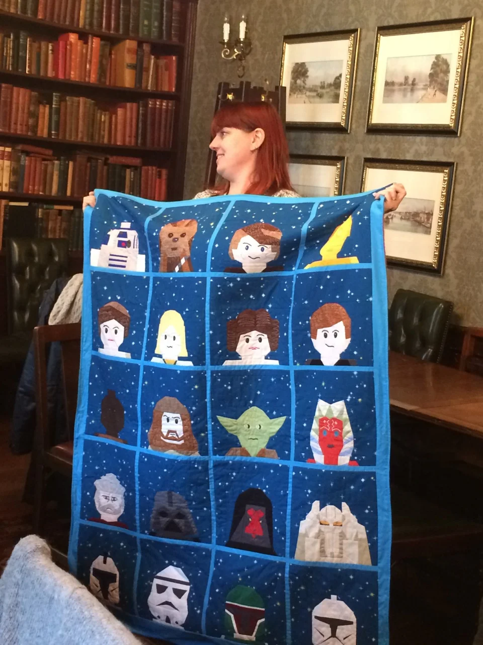 Apparently all of the faces are hand-pieced, and she made up two of them when unable to find a pattern. OMG! The backing ingeniously made use of a Lego Star Wars fleece blanket purchased from Legoland.