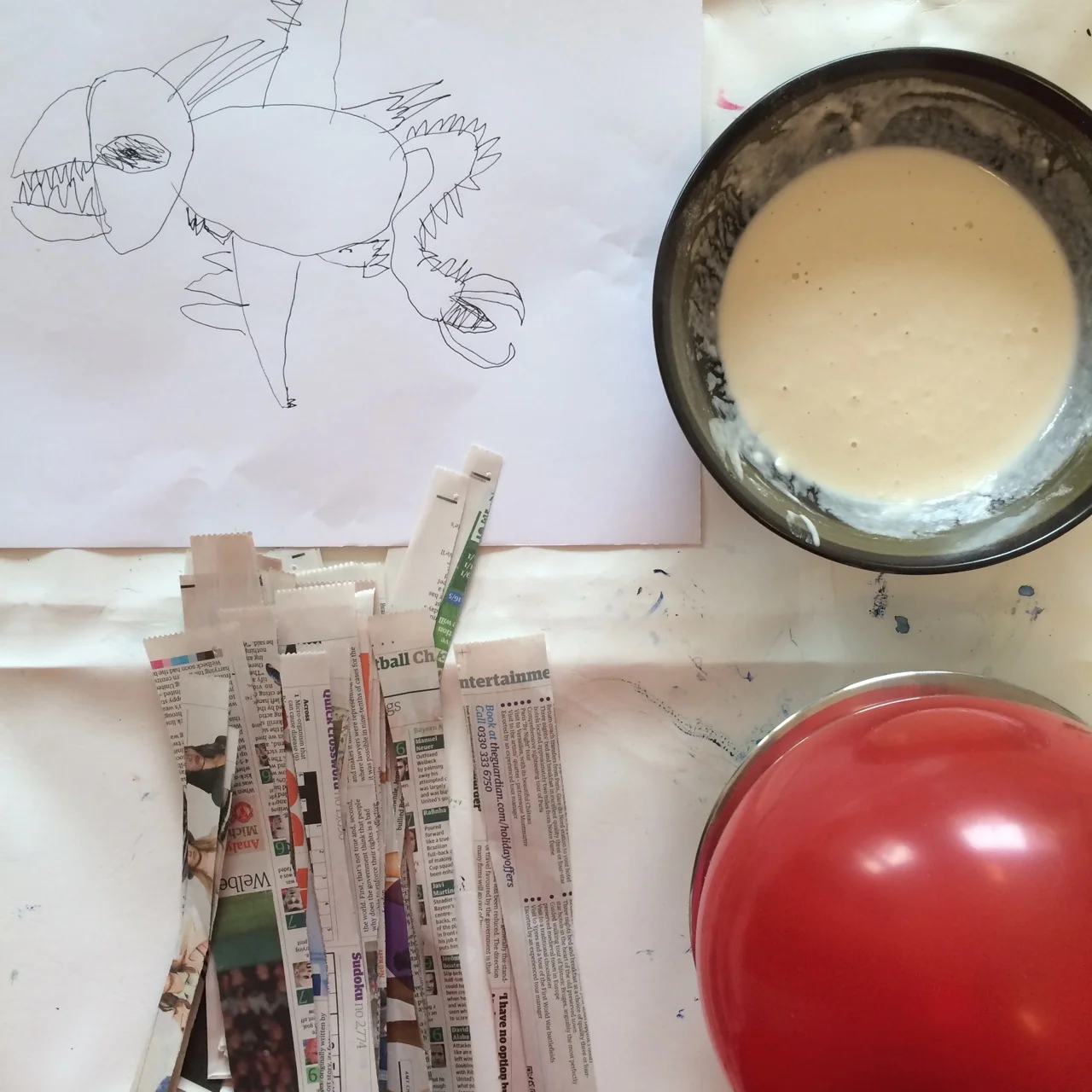 A drawing of the fierce dragon for inspiration and papier-mache materials ready to go!