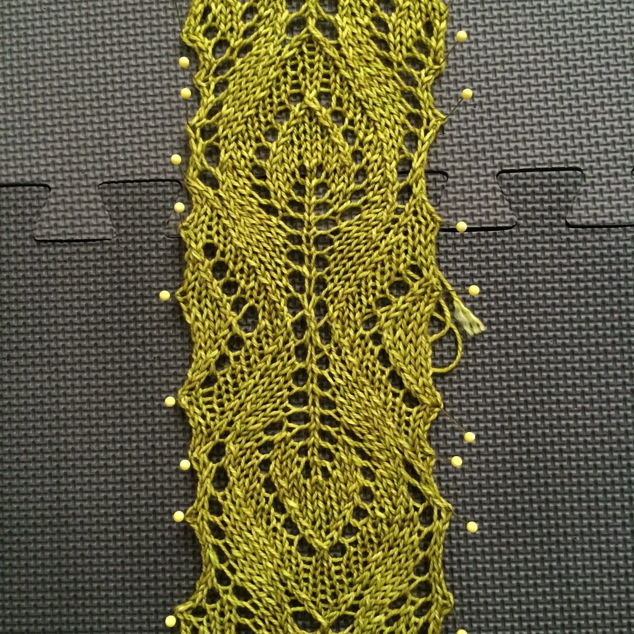 You can see here how the lace works outward from the centre in two directions. I love this gorgeous leaf motif. The lace panel needs to be blocked to the right width before you can pick up the stitches for the collar or the body. Which is why I was in a rush to get this done so that I could take it with me as my train knitting to Paris!