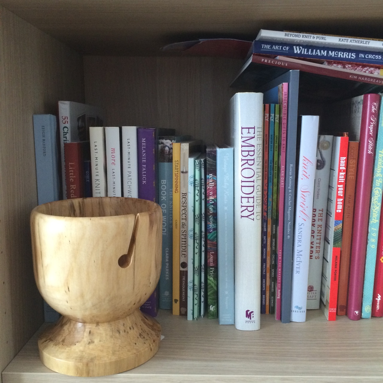 The Wooden Yarn Bowl and his strategic position on the shelf with the knitting books.