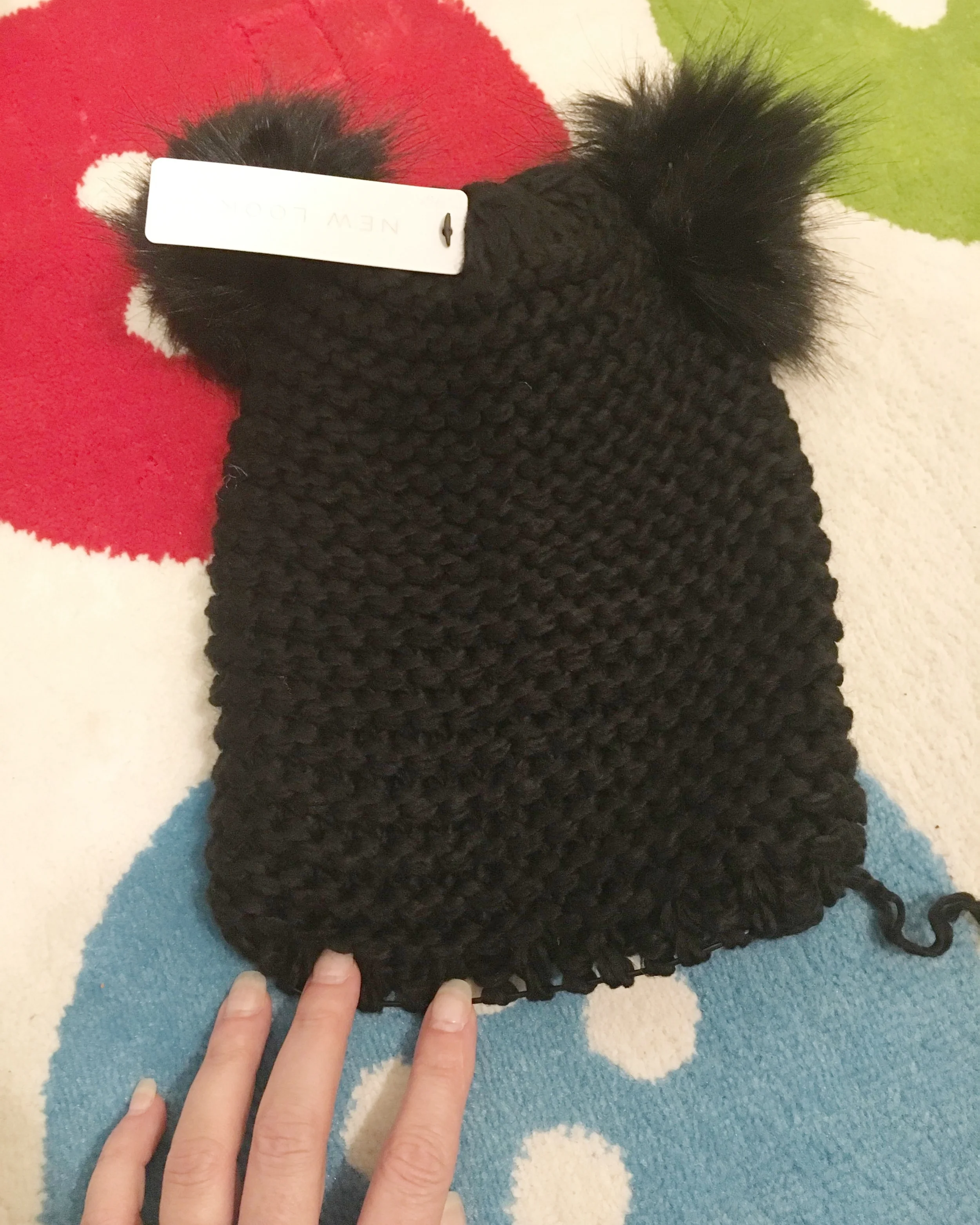 Hat after the brim was unravelled. Cute, but a little unfinished looking now. And man photographing black yarn is hard!