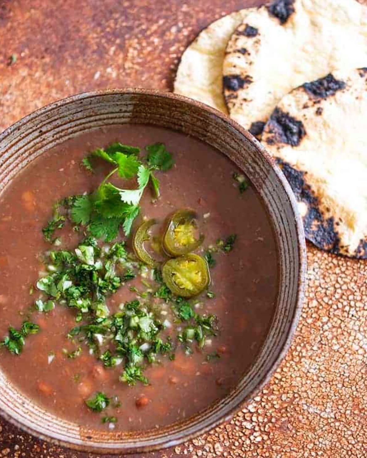 BEAUTIFUL FOOD BY DESIGN | Simply rich&ndash;Frijoles de la Olla. A pot of pinto beans simmered to perfect, creamy richness, then yielding to many a satisfying bowl, also serving as the building blocks of numerous other dining delights&ndash;a little
