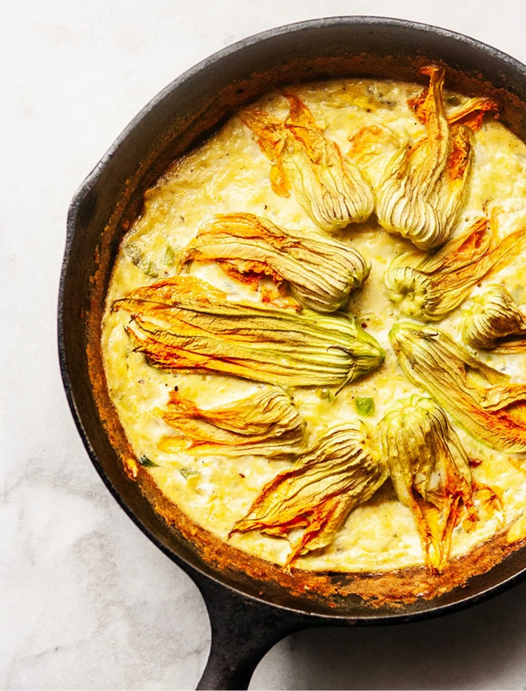 BEAUTIFUL FOOD BY DESIGN | NEW RECIPE Beautiful squash blossoms adorn this end of the season simple frittata recipe- No.618 Squash Blossom Frittata in the Membership Collection.

TAP BIO FOR RECIPE 
https://bijouxs.com/squash-blossom-frittata/
.
. 
#